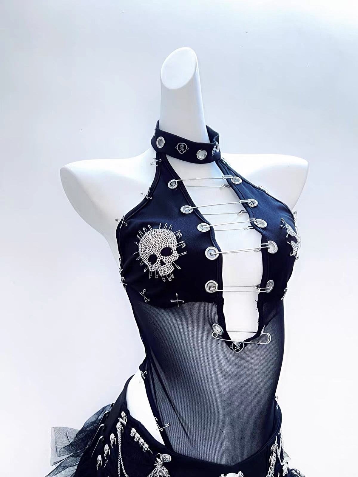 Black mesh halter bodysuit with skull rhinestone and safety pin details
