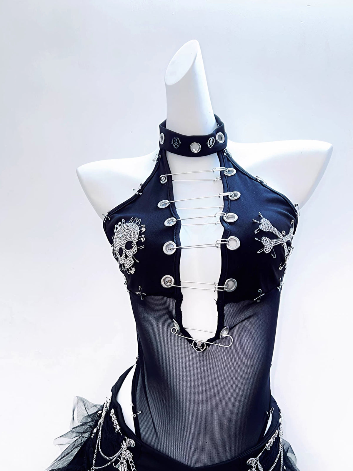 Black mesh halter bodysuit front view with safety pins and rhinestone motifs