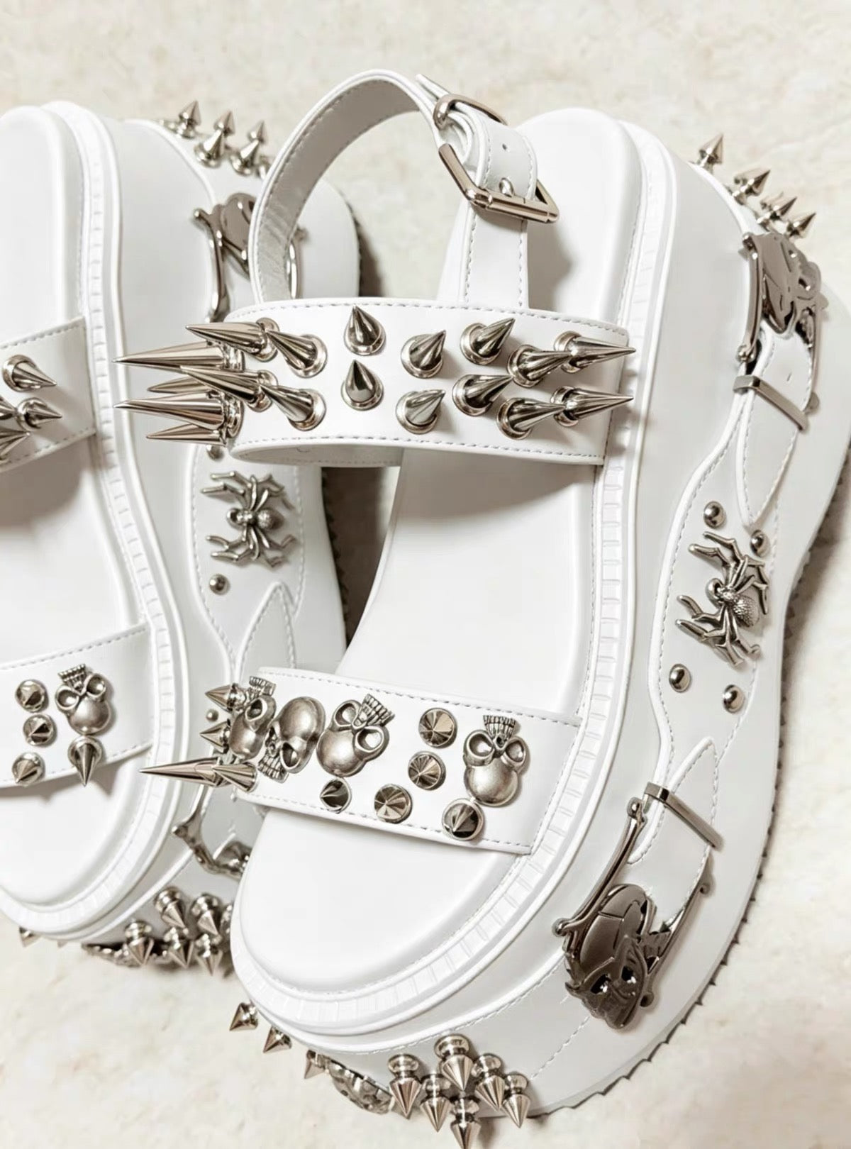 White spiked skull platform sandals with silver hardware