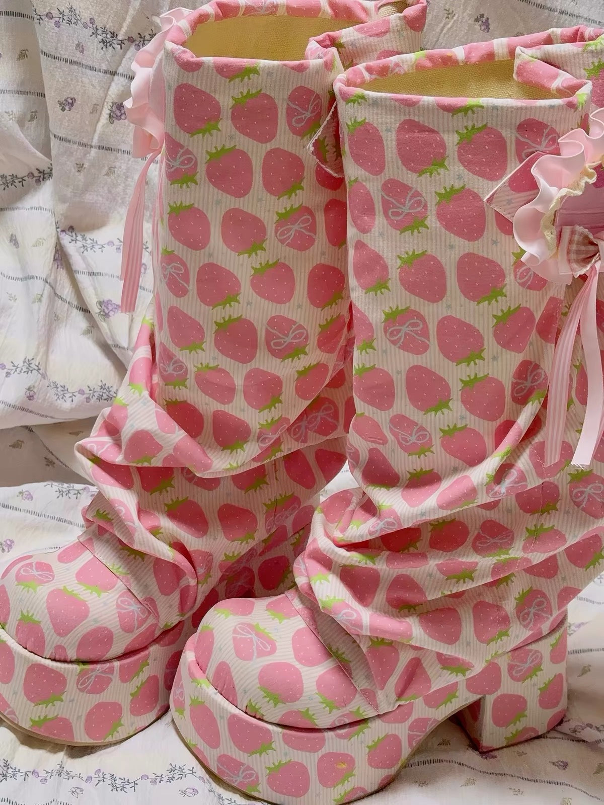 Pink strawberry print platform boots close view