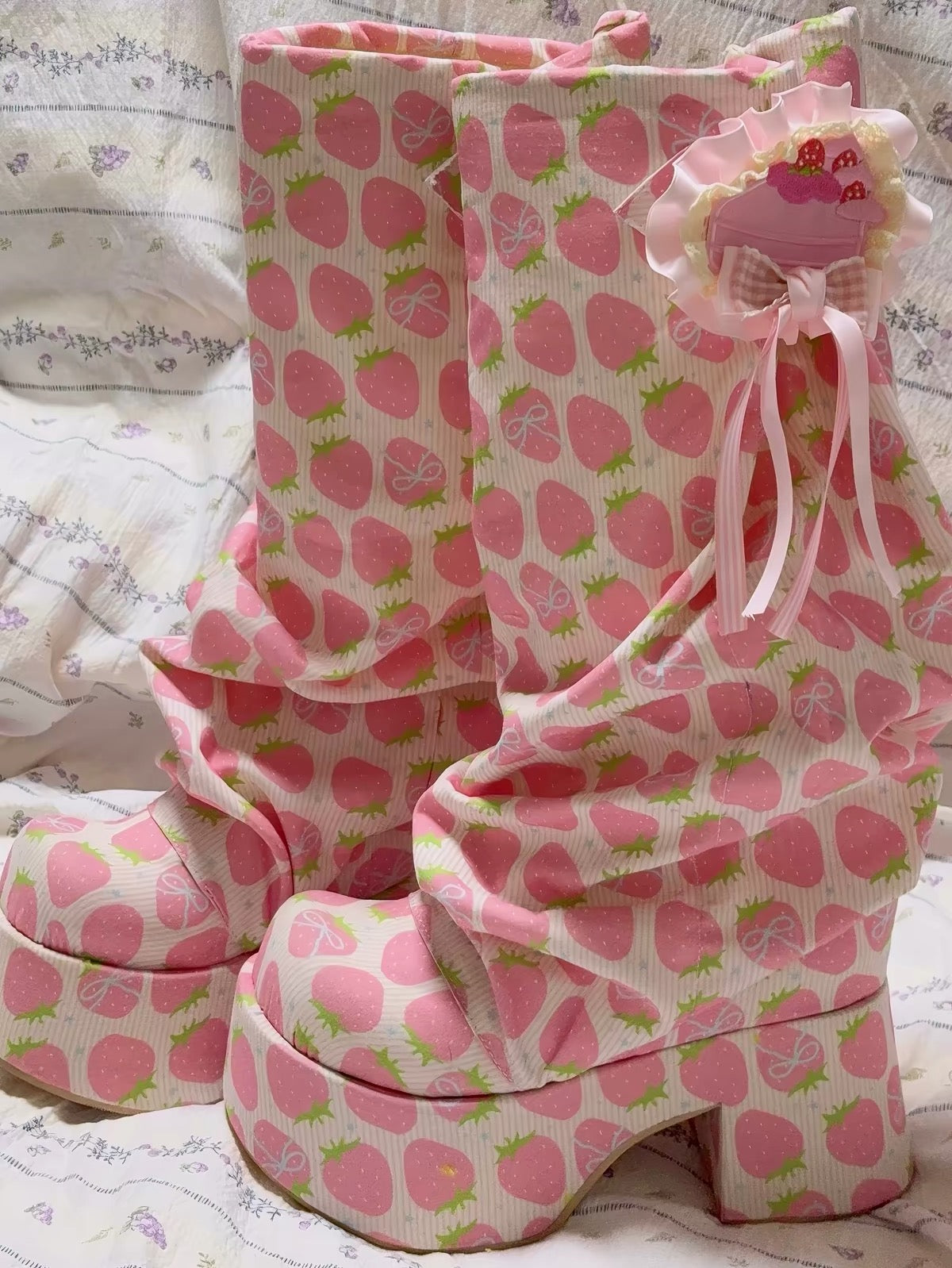 Pink strawberry print platform boots front view