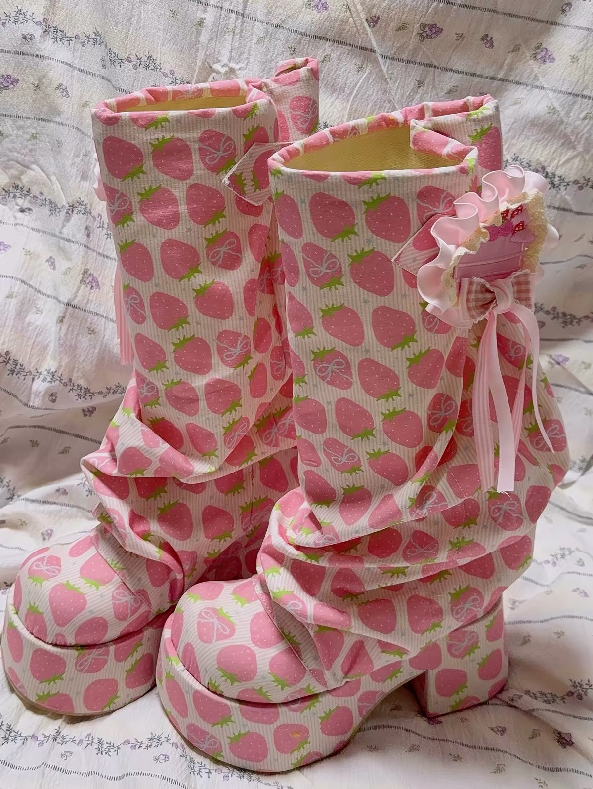 Pair of pink strawberry print platform boots