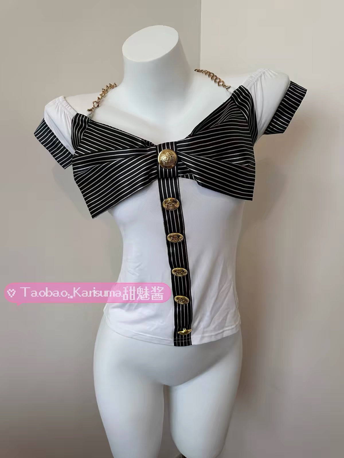 White fitted GAL top with black striped bow and gold buttons