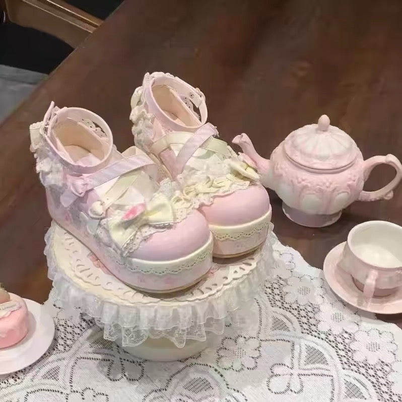 Pastel pink platform Lolita shoes styled with lace and bows