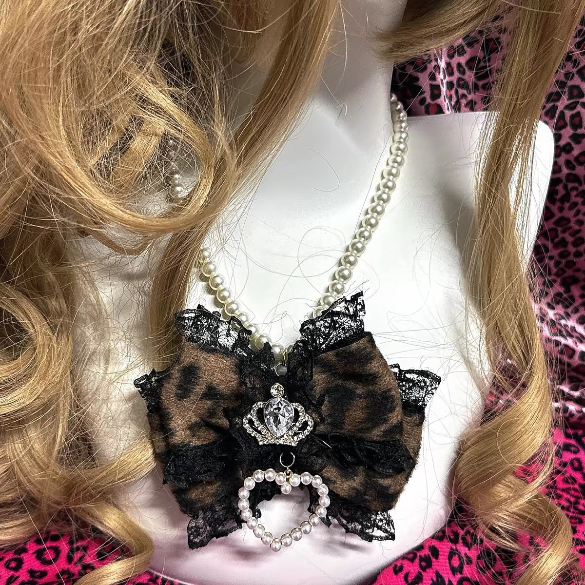 Brown leopard bow pearl necklace shown on mannequin