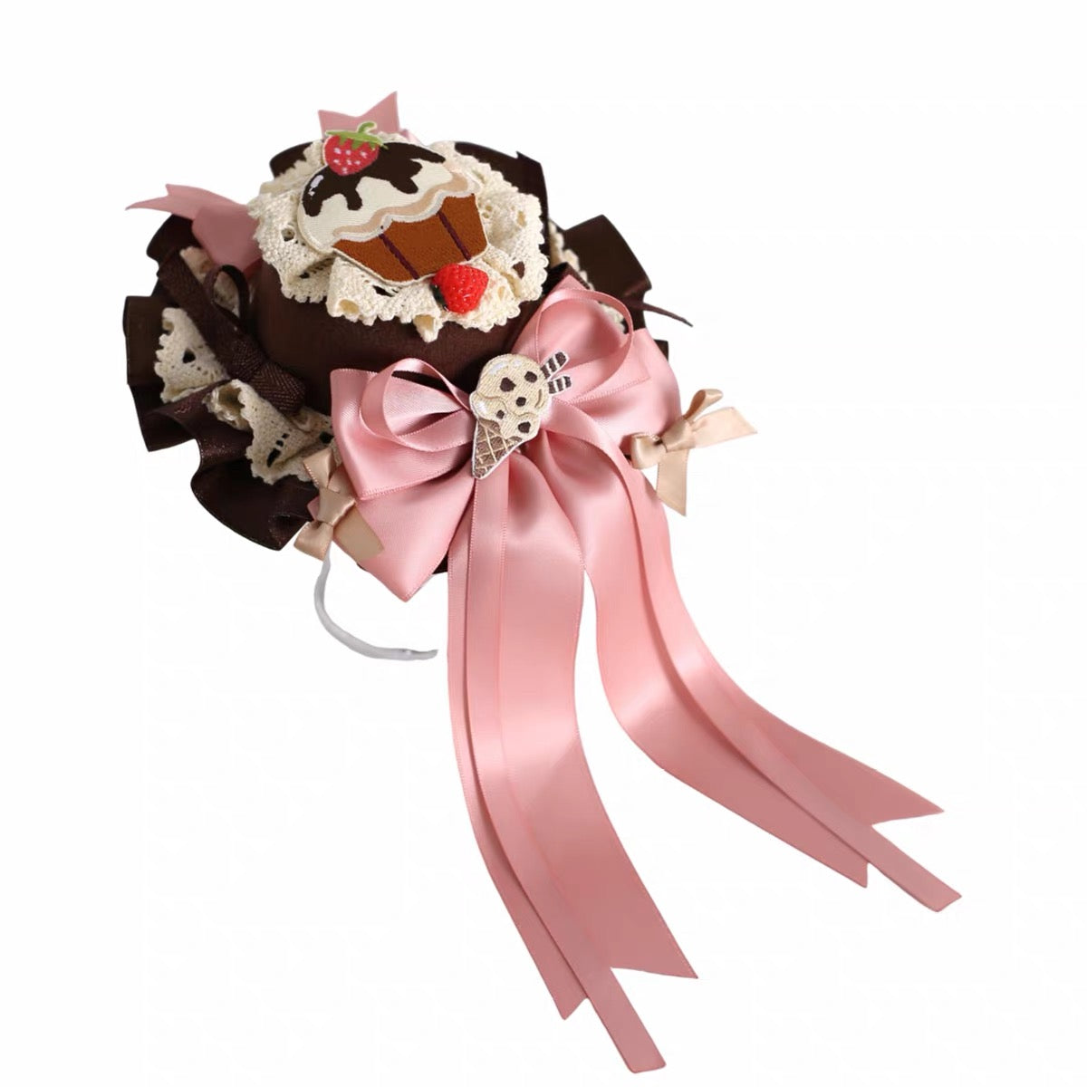 Chocolate and pink dessert-inspired headdress detail on white background