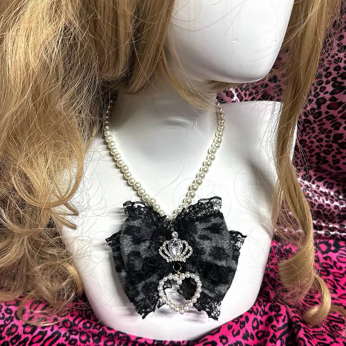 Gray-black leopard bow pearl necklace shown on mannequin