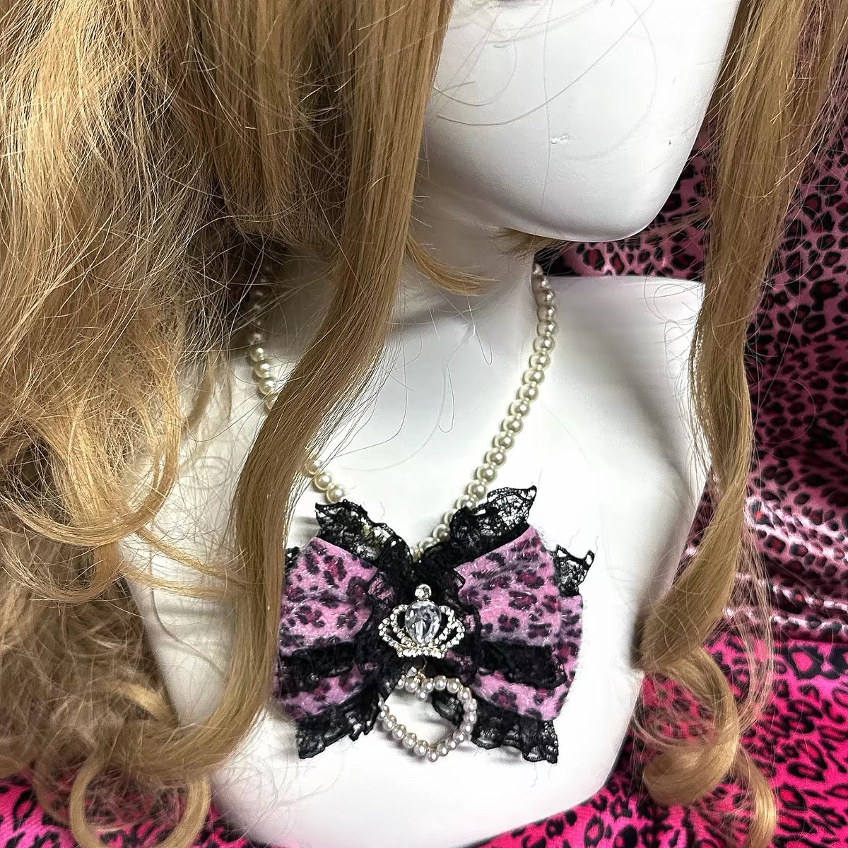 Pink leopard bow pearl necklace shown on mannequin