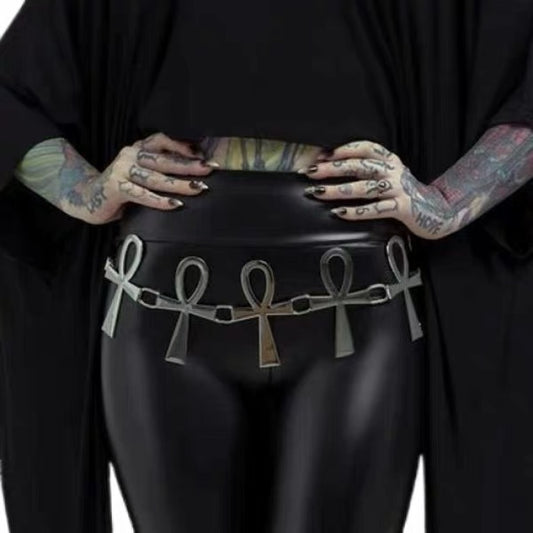 Silver-tone ankh chain belt styled over a black outfit