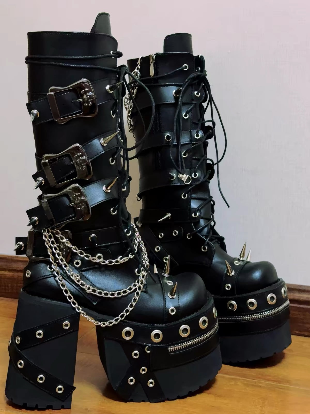 Black spiked chain platform boots detail view